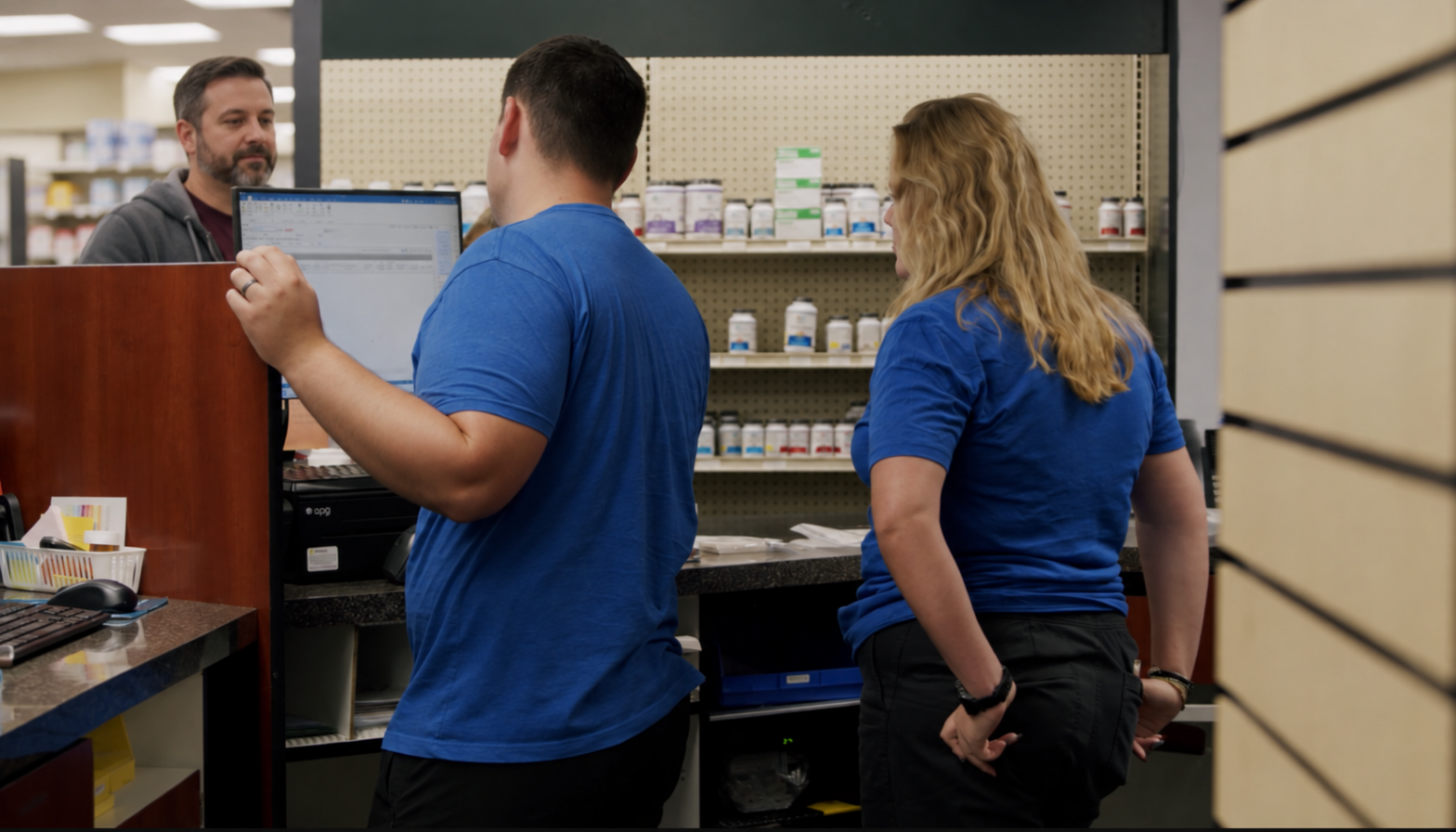 Customer waiting while pharmacy staff complete a prescription pickup