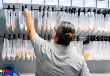 Pharmacy staff retrieving a prescription using the HangRx light-guided will-call