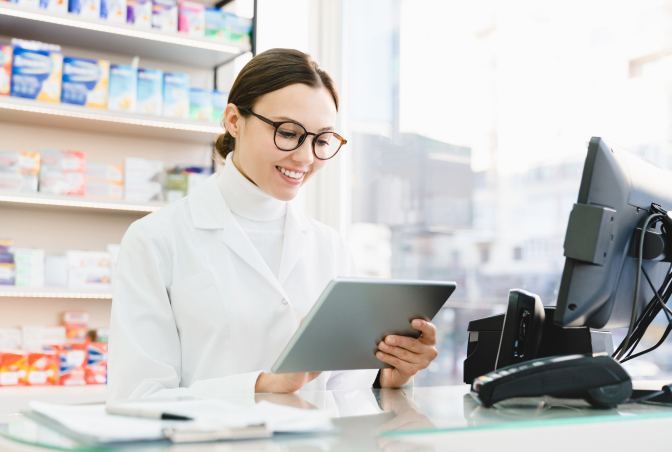 Pharmacist using a tablet, representing Suncrest Solutions' pharmacy management integration for a streamlined workflow